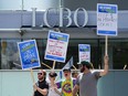 LCBO employees picket in front of a closed LCBO store in downtown Ottawa on Friday, July 5, 2024. The Liquor Control Board of Ontario says it no longer plans to open some retail stores for in-store shopping amid the ongoing strike.THE CANADIAN PRESS/Sean Kilpatrick