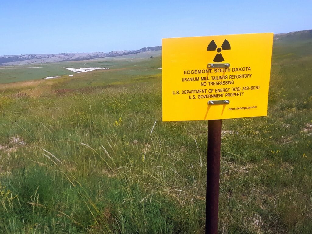 A sign identifies a repository near Edgemont where 4 million tons of radioactive tailings from a former uranium mill have been buried since the 1980s. (Seth Tupper/South Dakota Searchlight)