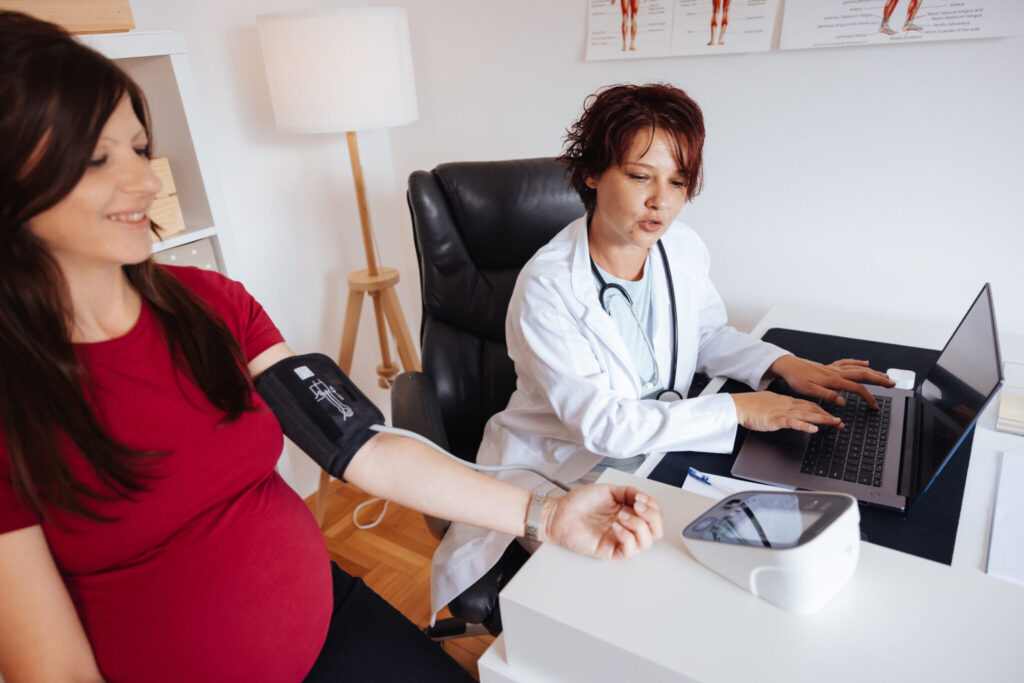 A doctor measures the blood pressure of a pregnant woman. (Getty Images)