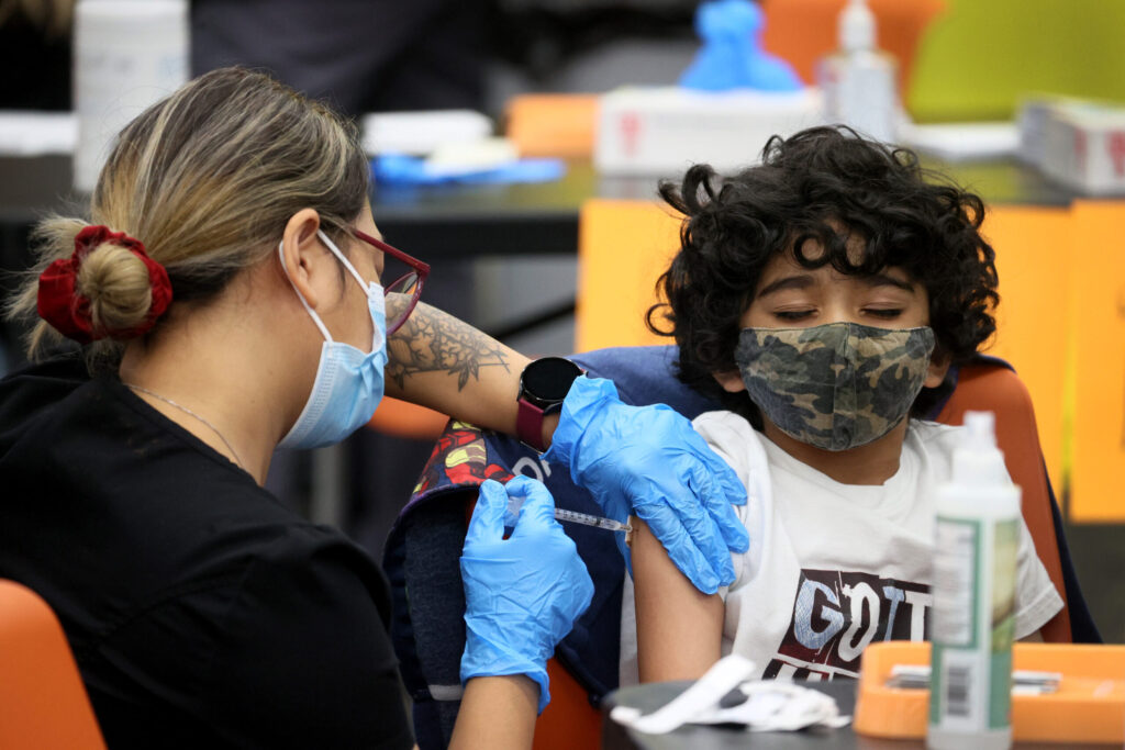 Seven-year-old Milan Patel receives a COVID-19 vaccine at Michele Clark High School on Nov. 12, 2021, in Chicago, Illinois. (Scott Olson/Getty Images)