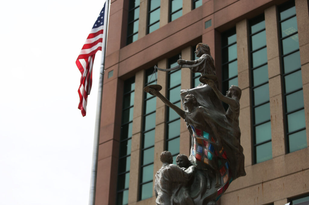 An equal justice statue stands outside the doors of the Minnehaha County Courthouse in Sioux Falls. (Makenzie Huber/South Dakota Searchlight)