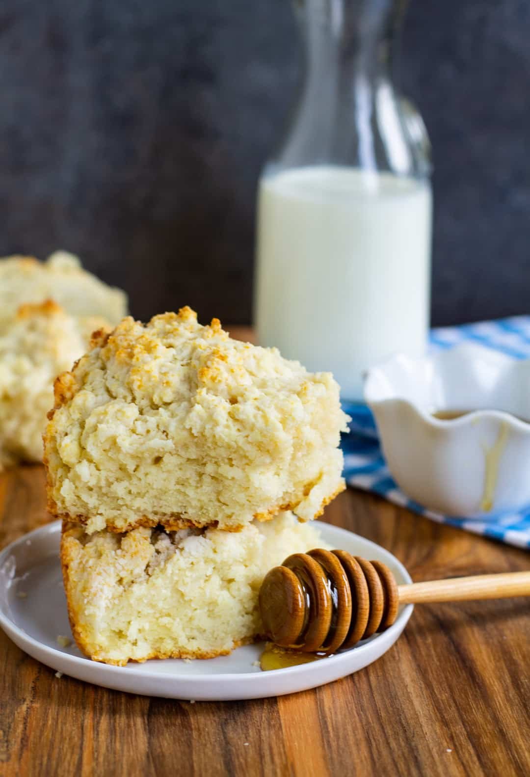 Two biscuits on plate with honey.