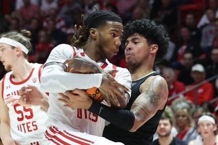 Feb 3, 2024; Salt Lake City, Utah, USA; Utah Utes guard Deivon Smith (5) and Colorado Buffaloes guard Julian Hammond III (3) battle for the ball during the first half at Jon M. Huntsman Center. Mandatory Credit: Rob Gray-USA TODAY Sports