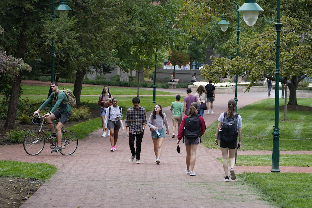 Students walk on a college campus.