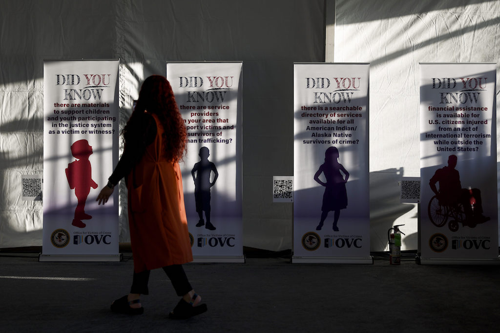 An An attendee looks at a series of banners for National Crime Victims' Rights Week.