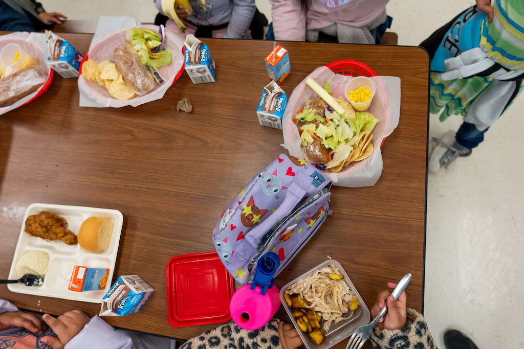 Elementary school students eating lunch.