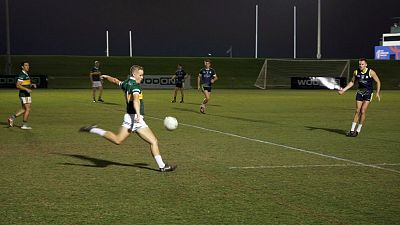 Kerry team player kicking for a point on the scoreboard. 