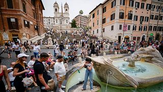 People line up to take fresh water from the historical Barcaccia fountain as temperatures reached 37 degrees Celsius, in downtown Rome.