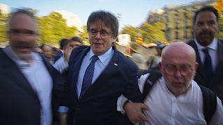 Catalan independence leader and former President Carles Puigdemont arrives to allegedly attend the investiture debate in Barcelona, Spain, Thursday, Aug. 8,