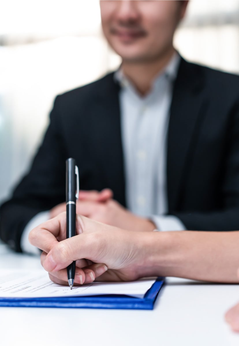 Close-up of a female hand signing a contract.