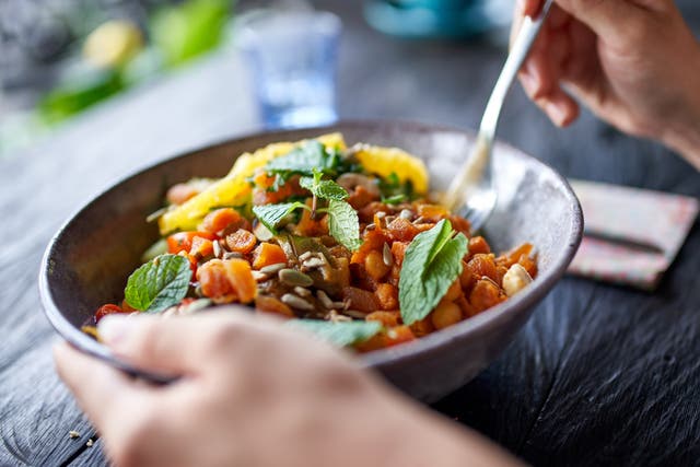 <p>A person eats a vegetarian meal</p>