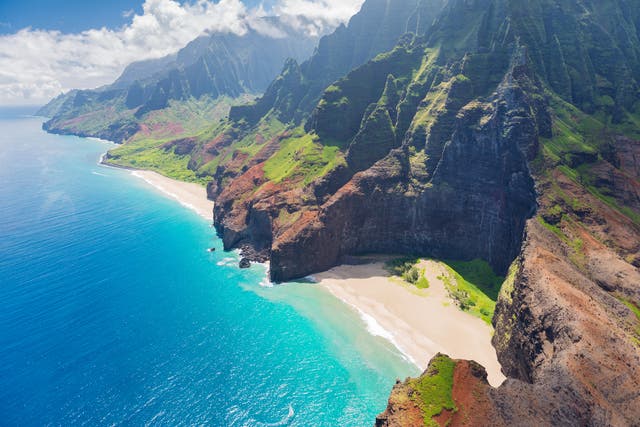 <p>The mountainous terrain near Kauai, Hawaii’s Na Pali coast. A helicopter operated by Ali’i Kauai Air Tours and Charters crashed off the Na Pali coast on July 11, leaving one person dead and two others missing (stock image) </p>