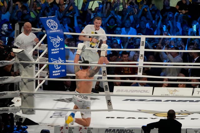 Ukraine’s Oleksandr Usyk celebrates after beating Britain’s Daniel Dubois (Czarek Sokolowski/AP)