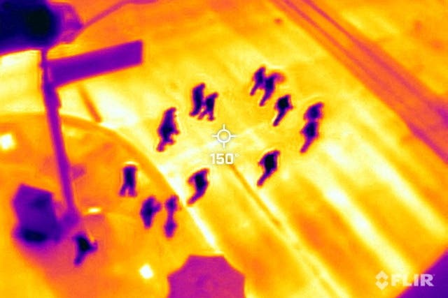 <p>Phoenix locals cross the road to watch baseball at Chase Field during an intense heatwave on 26 July </p>