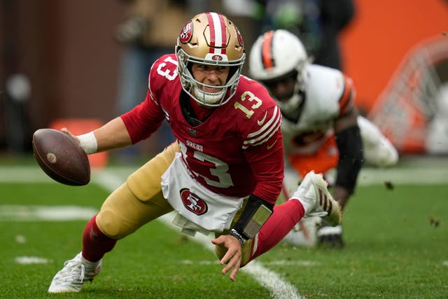 San Francisco 49ers quarterback Brock Purdy (13) scrambles away from Cleveland Browns linebacker Jeremiah Owusu-Koramoah (Sue Ogrocki/AP)