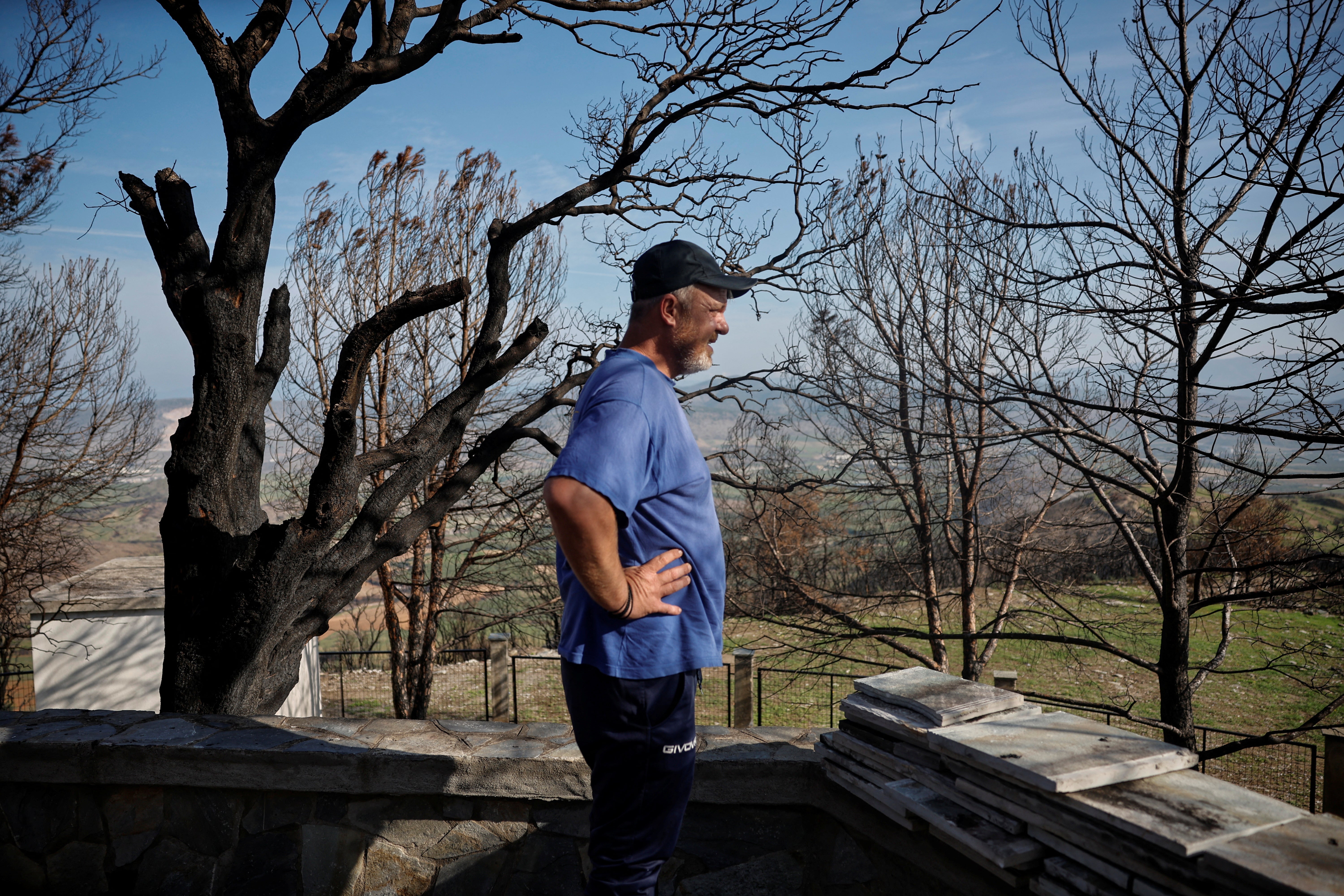 Tsiamitas looks over the damage caused by the wildfire, from the burned-out St John’s Church