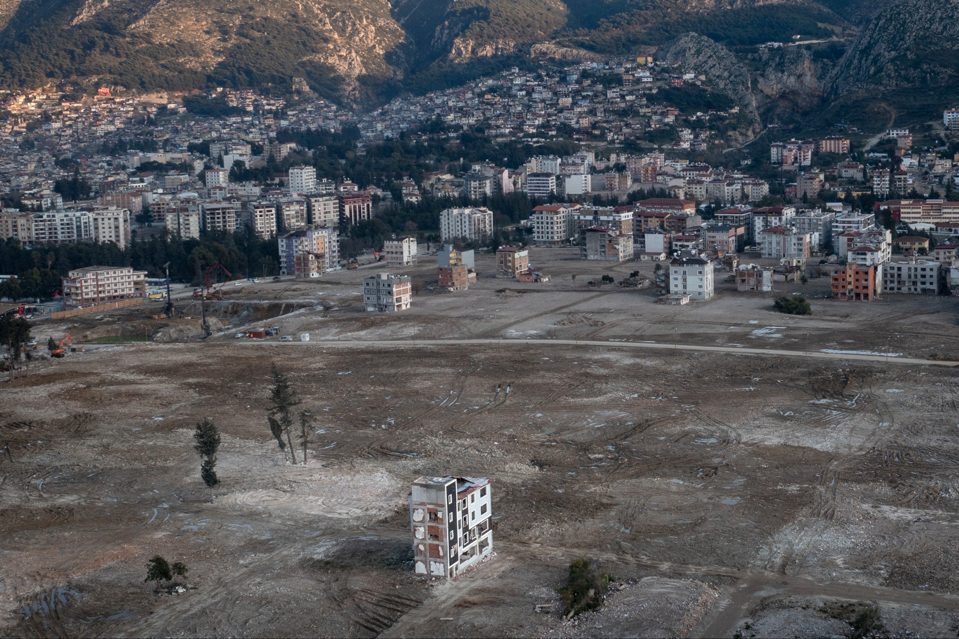 A lone apartment block stands where houses once stood in Turkey’s Hatay