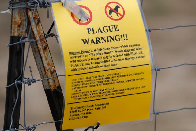 <p>A bubonic plague warning sign is displayed at a parking lot near the Rocky Mountain Arsenal Wildlife Refuge. </p>