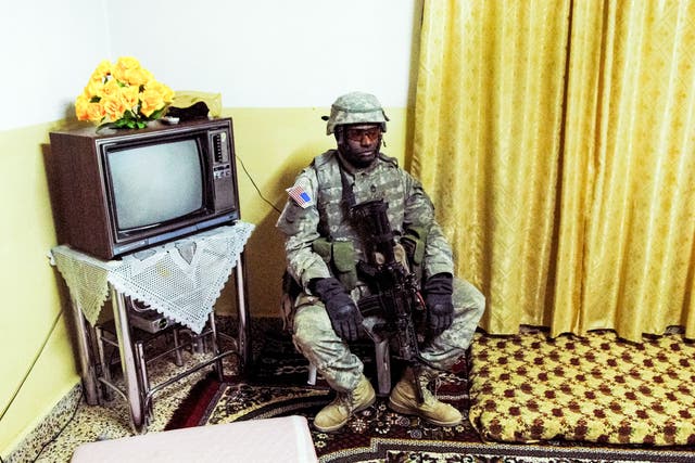 <p>An American soldier rests during a night raid in Rawa, Iraq in 2006 </p>