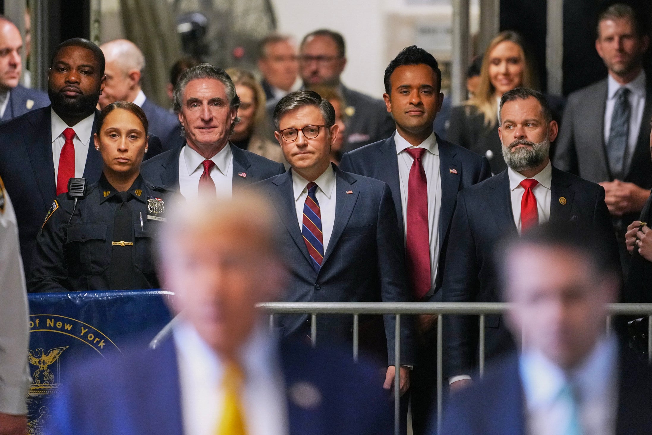 Mike Johnson (centre) at Trump trial, used on NYT’s front page