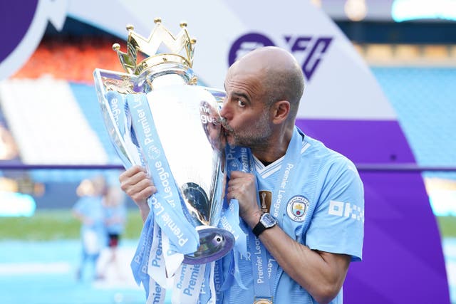 Pep Guardiola kisses the Premier League trophy (Martin Rickett/PA)