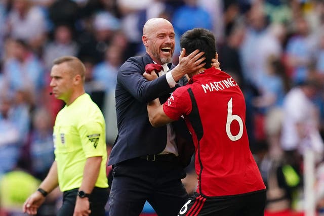 <p>Erik ten Hag celebrates with Lisandro Martinez (right) at the final whistle (John Walton/PA)</p>