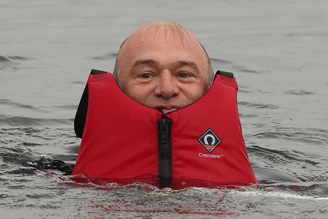 <p>Up to his neck in... the water crisis: Ed Davey in Lake Windermere this week </p>