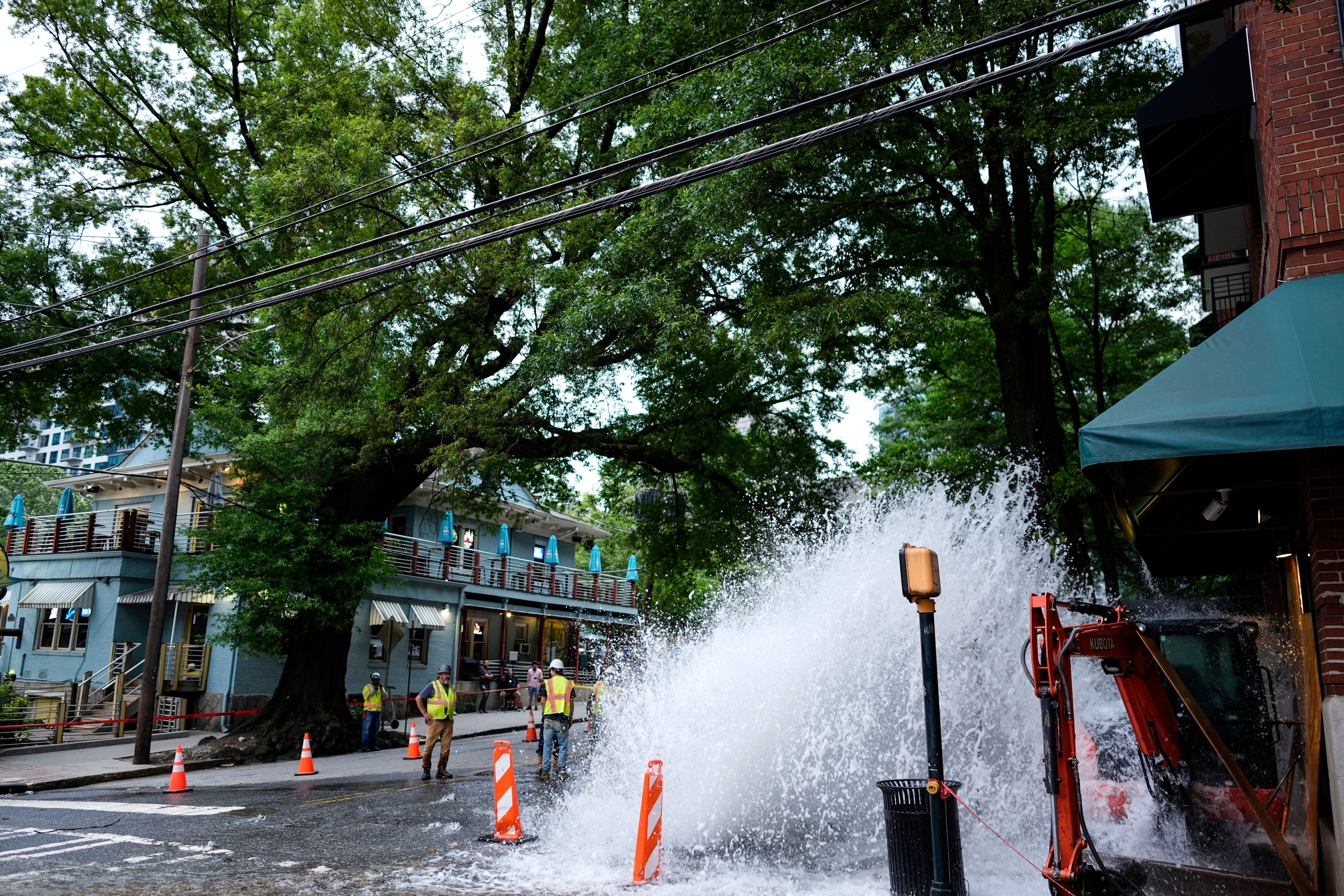 Water gushes out of a broken water transmission line in downtown Atlanta, Saturday, June 1, 2024