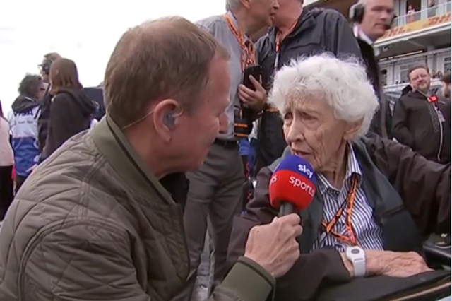 <p>Martin Brundle speaks to Mary McGee on the grid at the Canadian Grand Prix on Sunday</p>