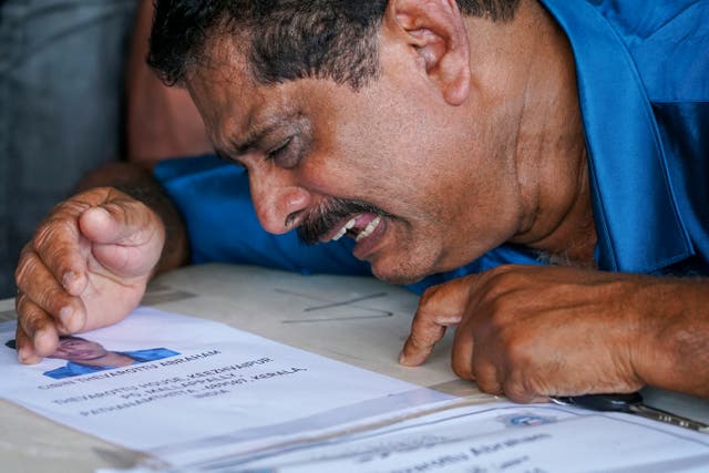 <p>A relative mourns near deceased Cibin Abraham after his coffin arrived on an Indian Air Force plane from Kuwait at the Cochin International Airport in Kochi </p>