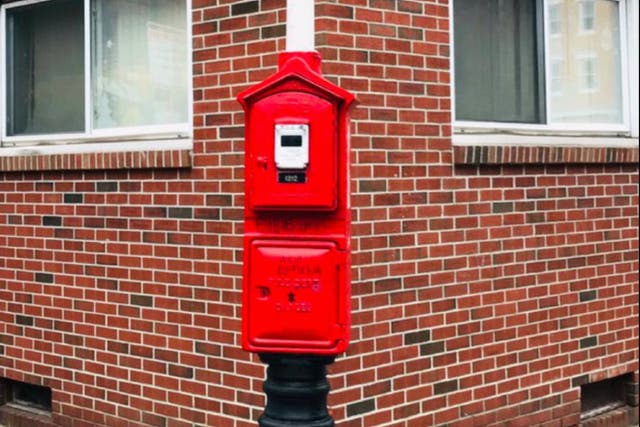 <p>A red firebox in Boston. After 911 services went down across Massachusetts on Tuesday, the Boston Fire Department advised residents to use the boxes to alert firefighters to emergencies</p>