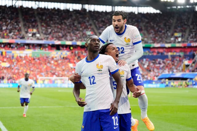 <p>France celebrate after Randal Kolo Muani’s deflected shot found the Belgian net </p>