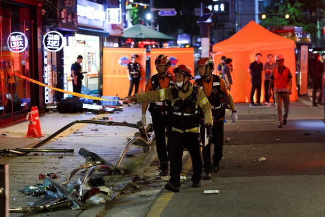 <p>Rescuers work at the scene of car accident that resulted in several people killed and injured in central Seou</p>