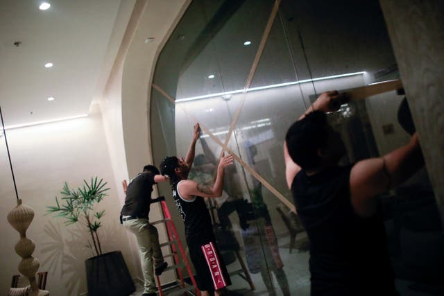 <p>Workers of the Motto by Hilton Hotel put tape on windows, ahead of the arrival of Hurricane Beryl, in Tulum, Mexico, July 5, 2024</p>