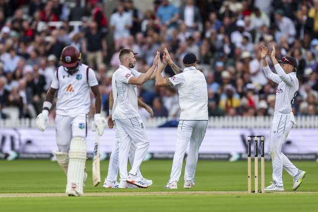 Gus Atkinson and Zak Crawley celebrate a wicket (Steven Paston/PA)