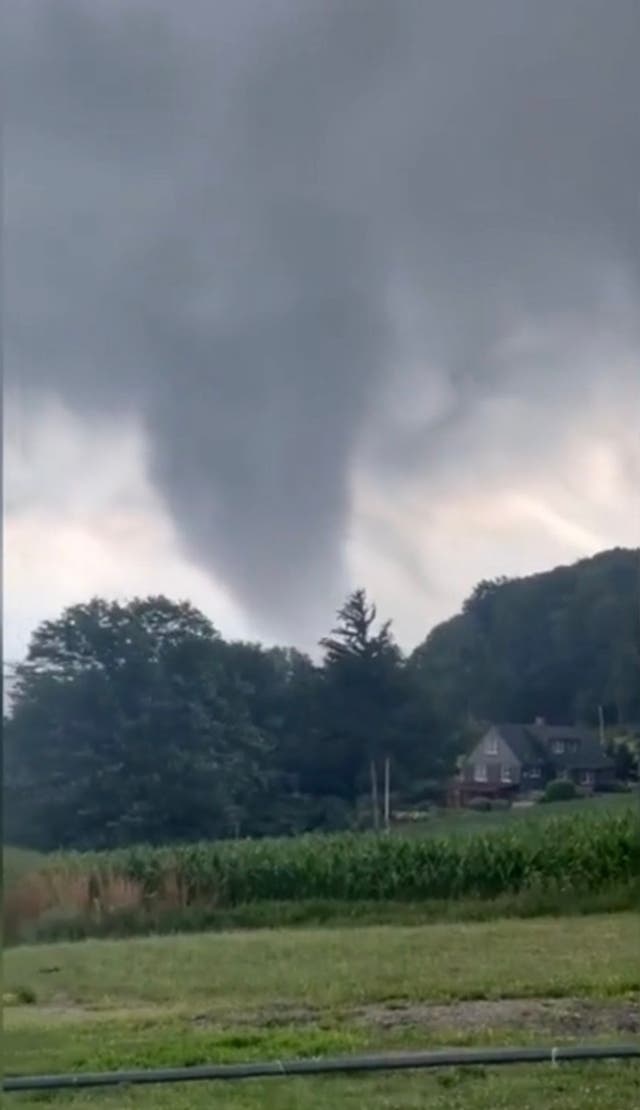 <p>A tornado rips through fields in Eden, New York on 10 July. At least six tornadoes touched down in New York state on Wednesday as the remnants of Hurricane Beryl battered the east coast</p>