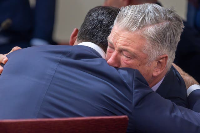 <p>Alec Baldwin, right, hugs his defense attorney Alex Spiro after District Court Judge Mary Marlowe Sommer threw out the involuntary manslaughter case for the 2021 fatal shooting of cinematographer Halyna Hutchins during filming of the Rust movie </p>