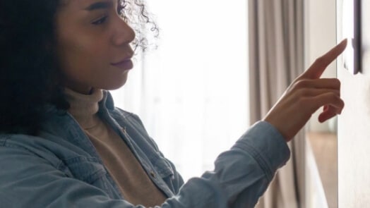 Woman adjusting home monitoring system