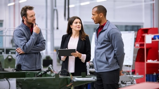 Three IT professionals discussing solutions