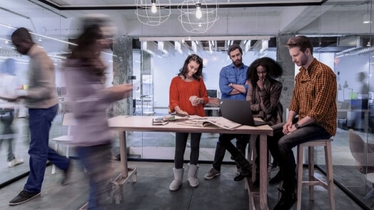 Man and woman in conference room with video call ongoing