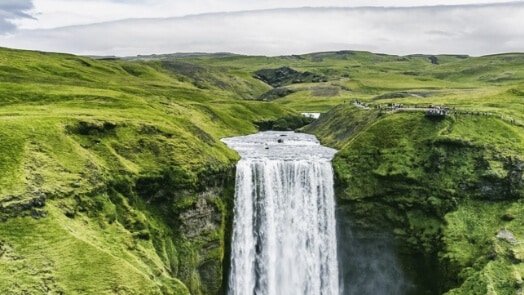 Man standing near a waterfall