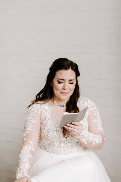 bride crying reading personal vows from groom