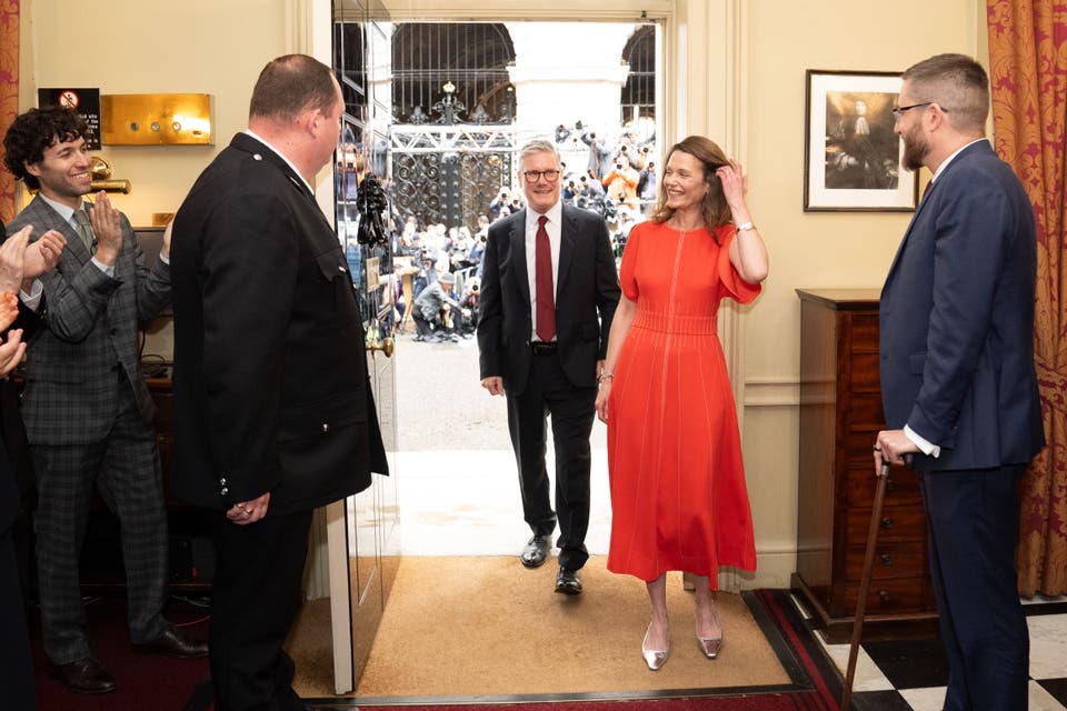 Newly elected Prime Minister Sir Keir Starmer with his wife Victoria Starmer are clapped in by staff (Stefan Rousseau/PA)