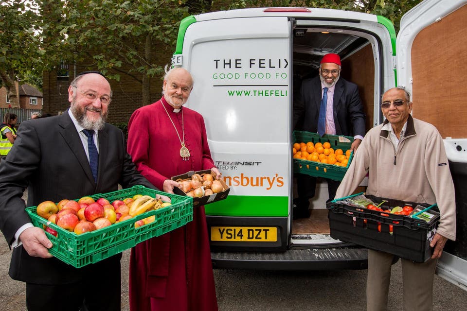 Service: Chief Rabbi Ephraim Mirvis, far left, Bishop Richard Chartres, Imam Monawar Hussain and Hindu temple manager Chandresh Thakkar help on a Felix delivery