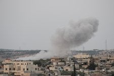 A plume of smoke rises after an airstrike hit a camp for displaced families near the town of Hass in Idlib province, Syria on Aug. 19th, killing 19 residents. The Times verified the minute the photograph was taken and used cockpit recordings to trace the strike to a Russian pilot.