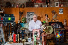 Tony Oursler in his New York City studio, with his collection of occult-related memorabilia, including various masks, voodoo objects and an early 20th-century Spectro-Chrome machine (left), which was purported to cure almost any human ailment.