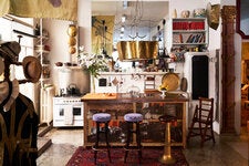 Gerosa made the kitchen island from a wooden door he found when he moved into the building. Above, a brass pendant lamp of his own design.