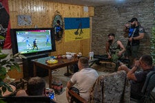 Ukrainian soldiers gathered in a bunker to watch their country’s team play Romania on Monday. Romania won, 3-0.