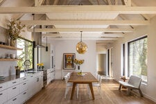 Leah Martin and Vikram Prakash built a second home for their family on Orcas Island, in northwest Washington. (The pendant over the table was designed by Julie Conway, of Illuminata.)