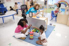Michaela Frederick, a pre-K teacher in Sharon, Tenn., playing a stacking game with a student.